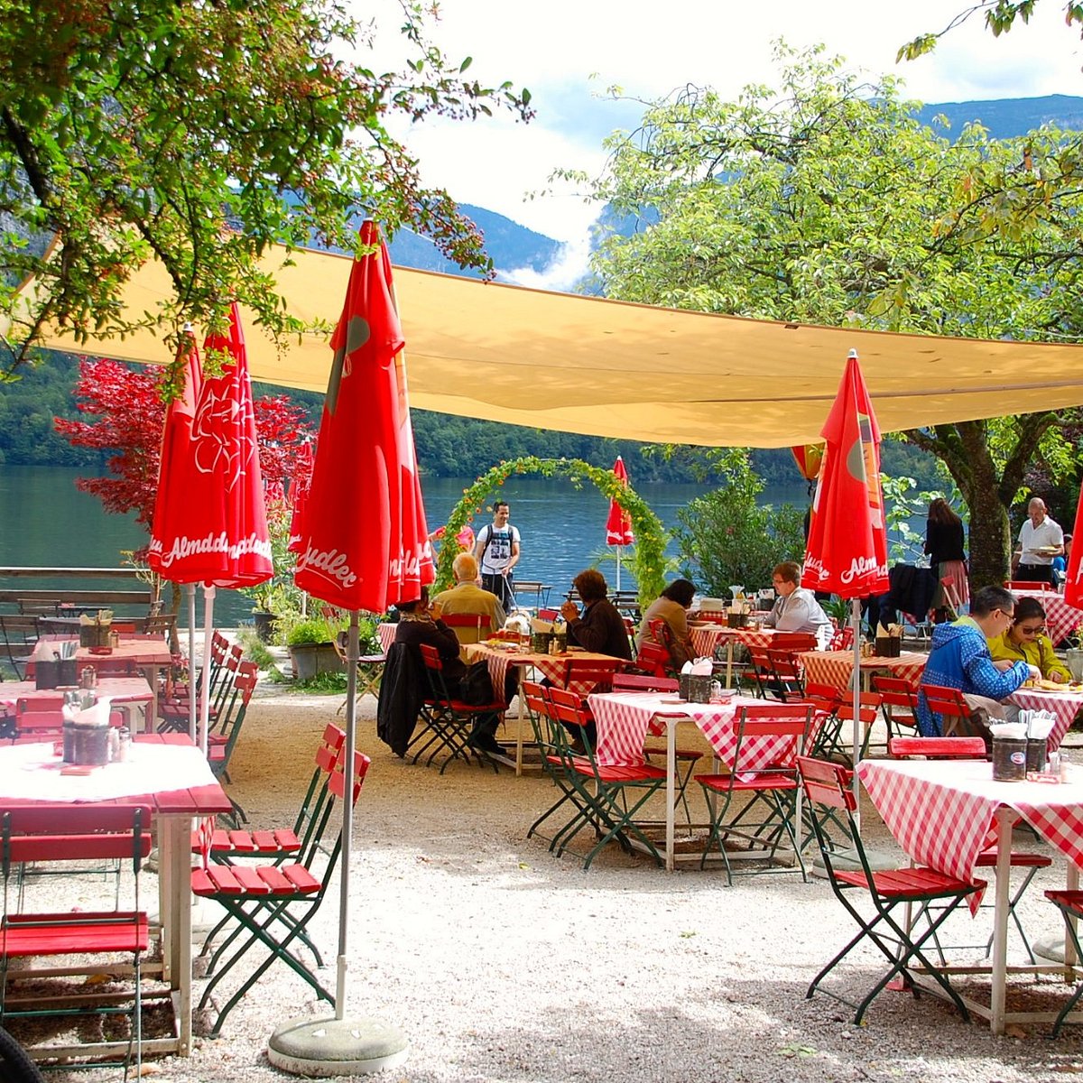 Red-and-white tables on the Restaurant am See lakeside terrace